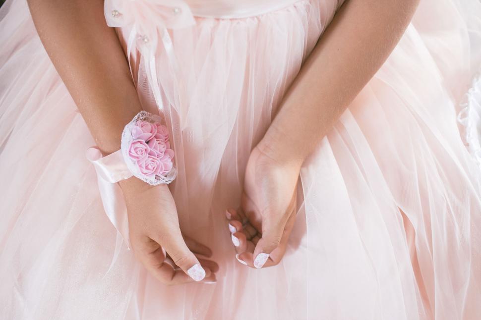 Free Image of Close-up of hands with elegant pink dress 