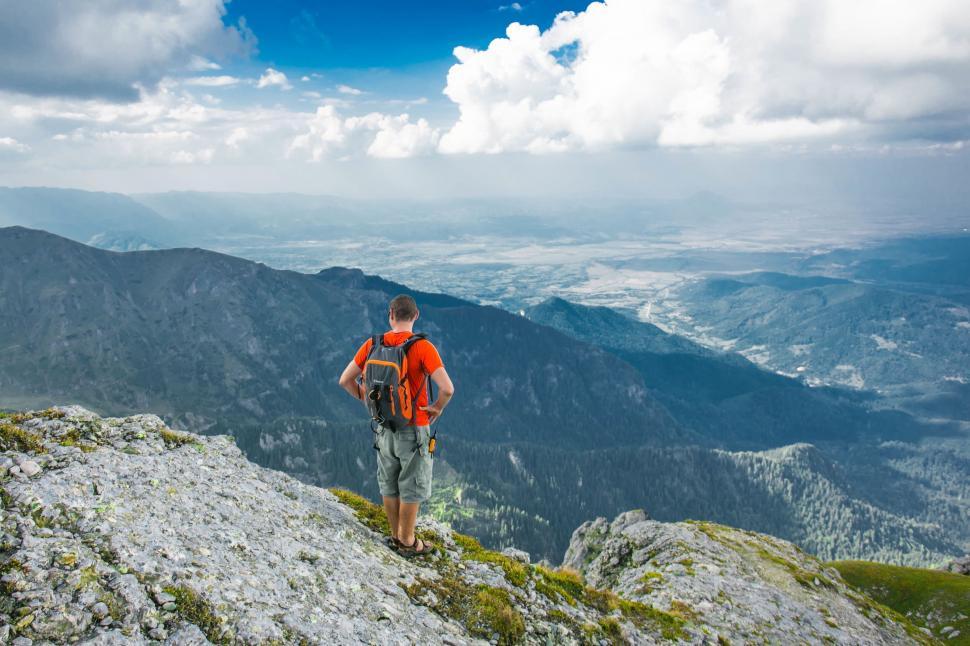 Free Image of Hiker overlooking vast mountain landscape 