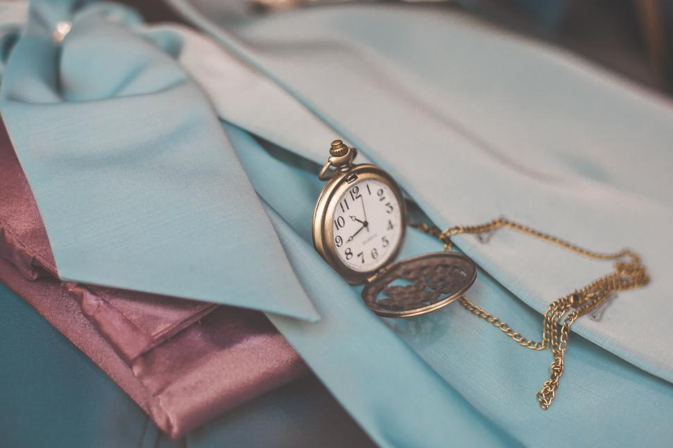 Free Image of Antique pocket watch on blue fabric 