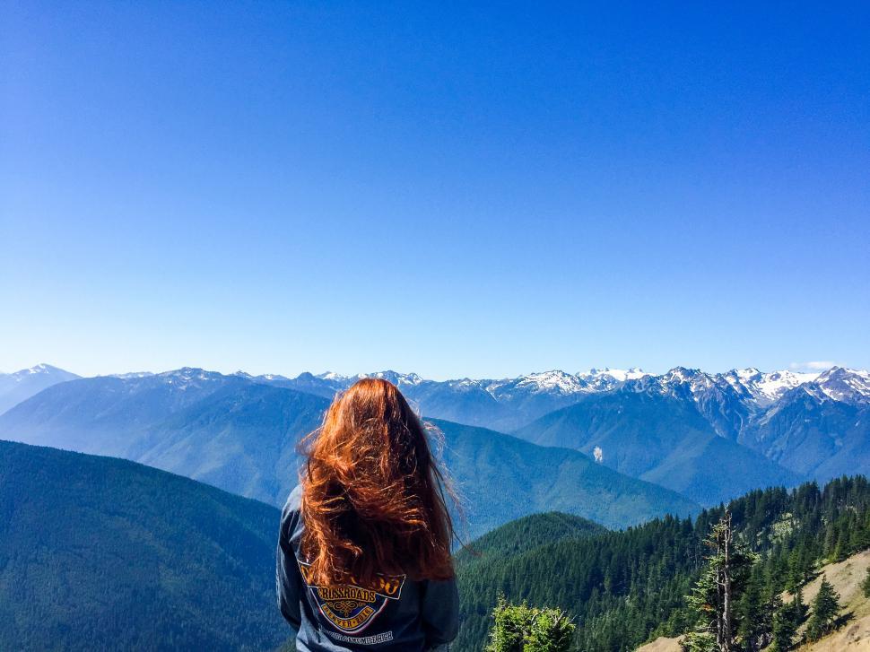 Free Image of Woman overlooking majestic mountain range 