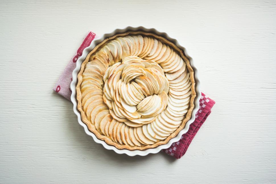 Free Image of Apple tart on white table with lilac napkin 