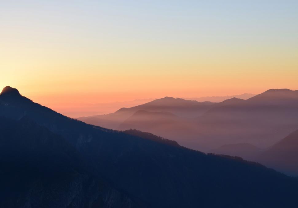 Free Image of Mountain range bathed in sunrise light 
