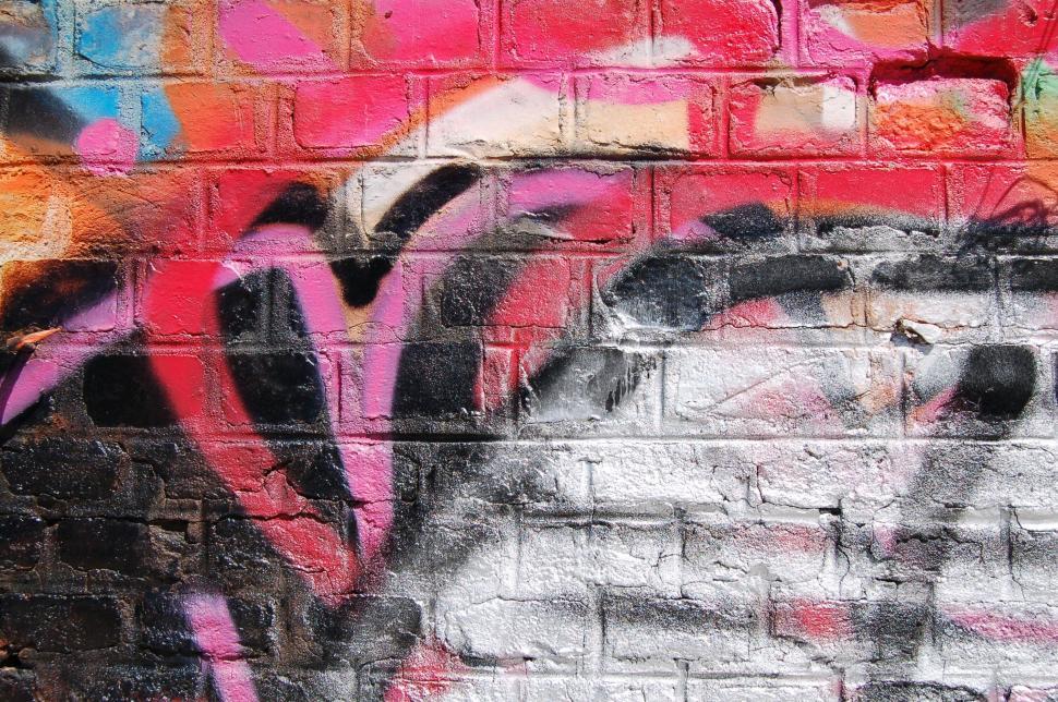 Free Image of Close-up of vivid graffiti on a brick wall 