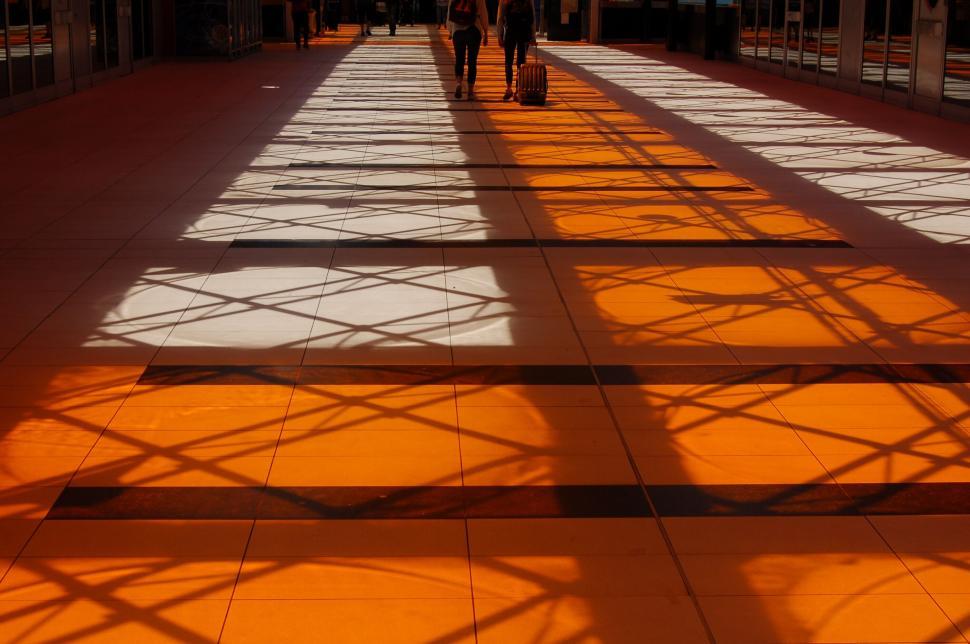 Free Image of Sunlit station floor casting geometric shadows 