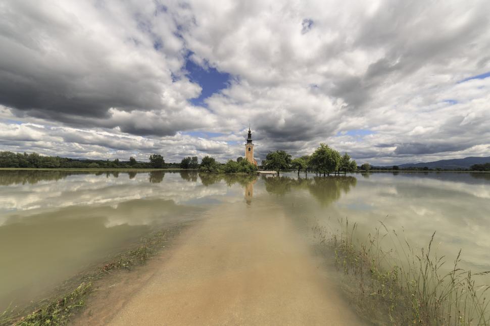 Free Image of A body of water with a tower and trees 