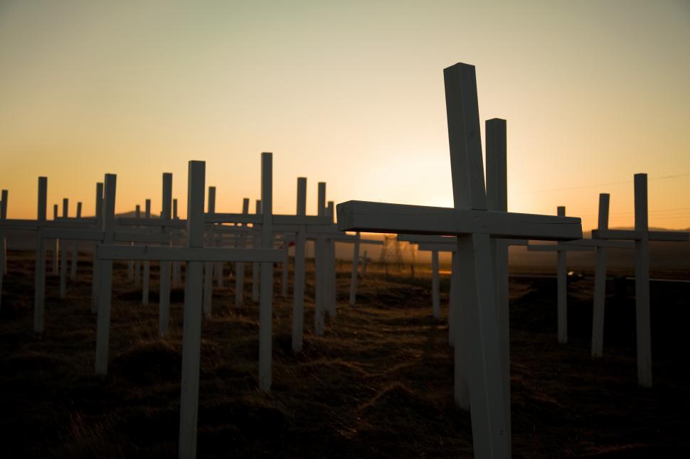 Free Image of A group of white crosses in a field 