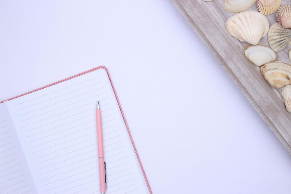 Free Image of Blank notebook with seashells on a desk 