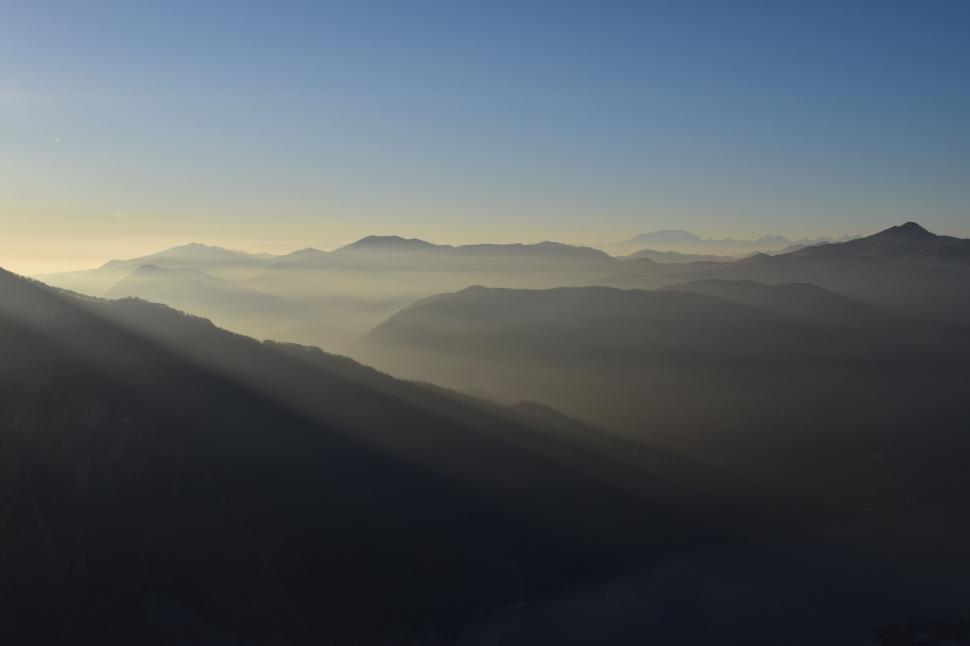 Free Image of Misty sunrise over layered mountain ridges 