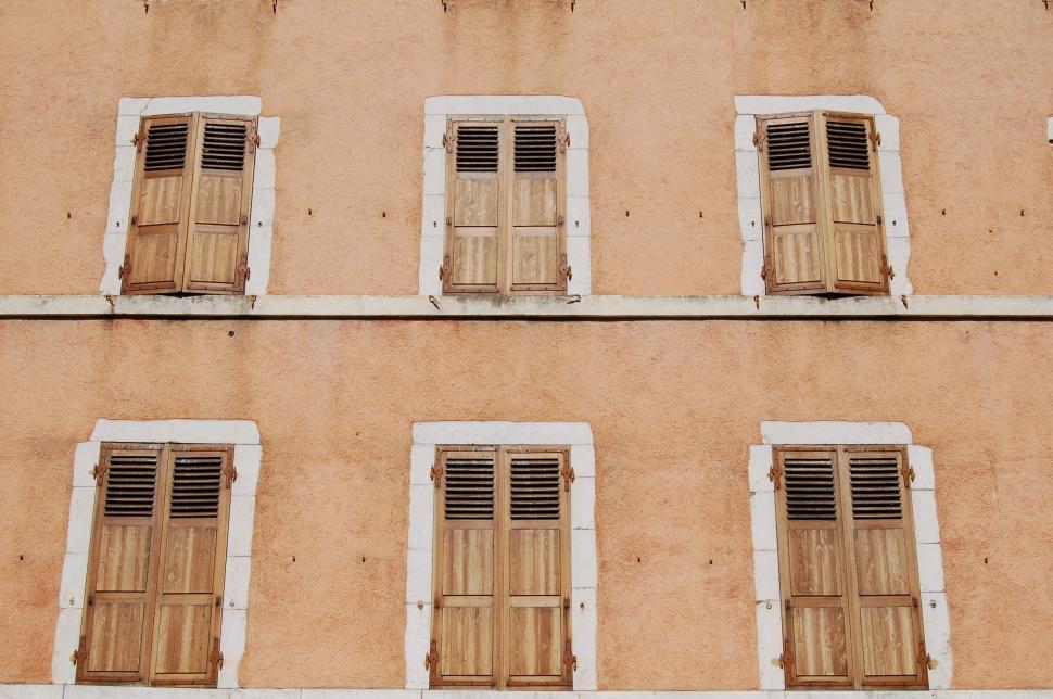 Free Image of Rustic shuttered windows on facade 