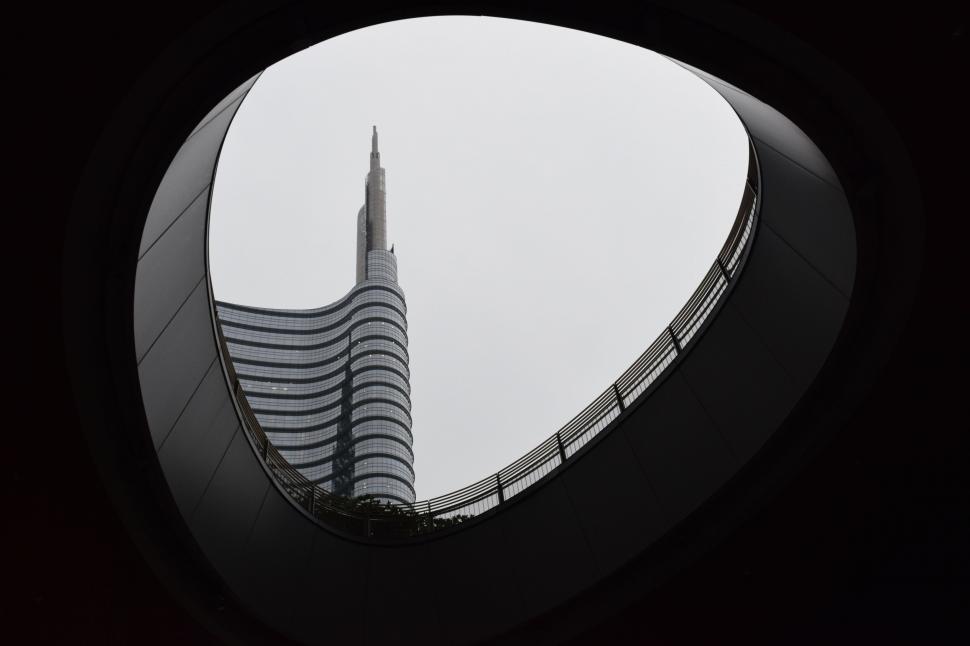 Free Image of Modern skyscraper seen through oval frame 