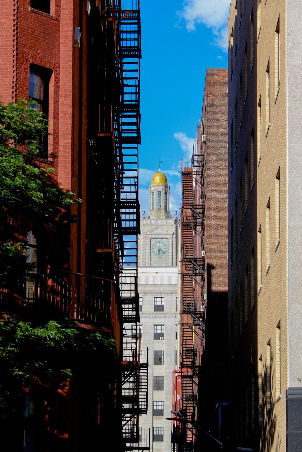 Free Image of Narrow alley with a view of a clock tower 