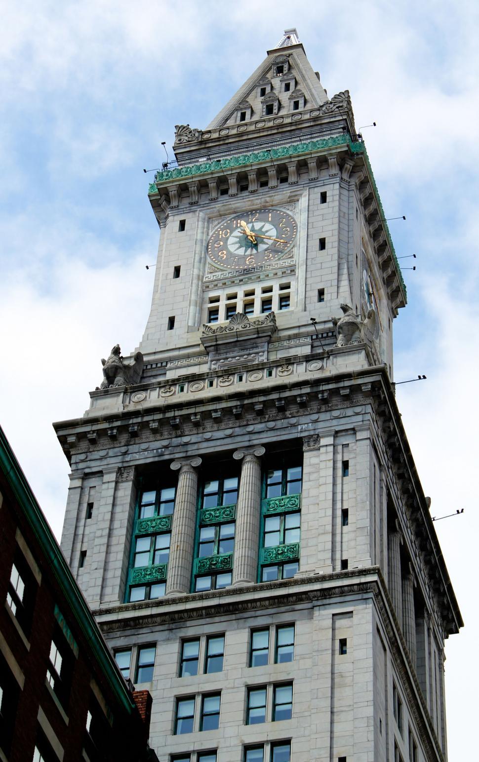 Free Image of Historic clock tower amidst modern buildings 