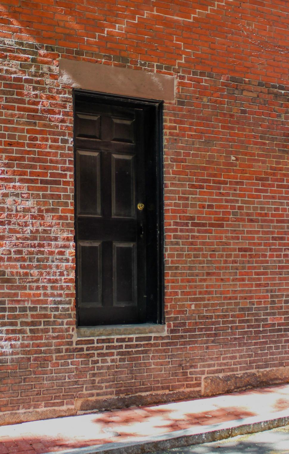Free Image of Classic black door on a brick wall 
