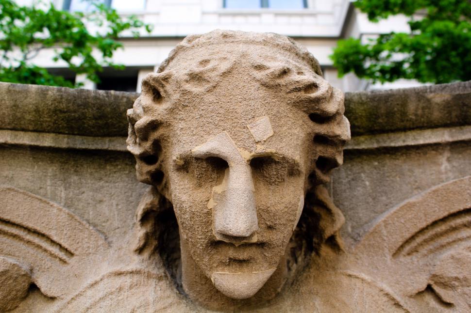 Free Image of Stone face sculpture with repairs 