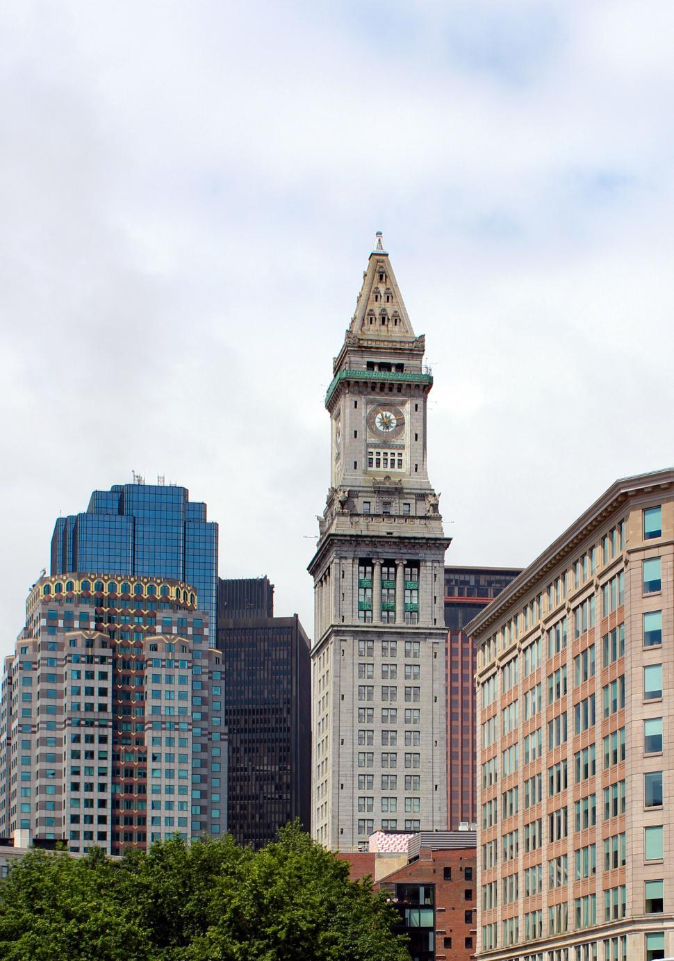 Free Image of Historic clock tower among modern skyscrapers 