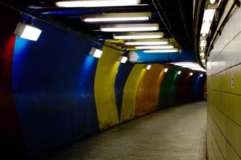 Free Image of Colorful illuminated underground passage with curved walls 