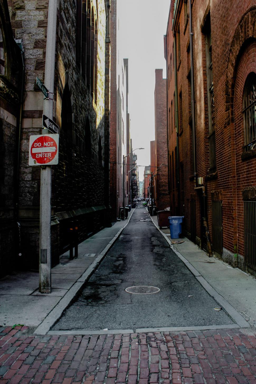 Free Image of Desolate street view with vintage brick buildings and signs 
