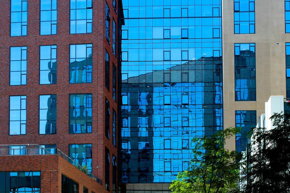 Free Image of Reflection of a cityscape in blue glass windows 