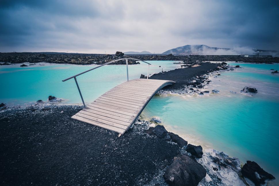Free Image of Bridge over vibrant blue geothermal spa waters 