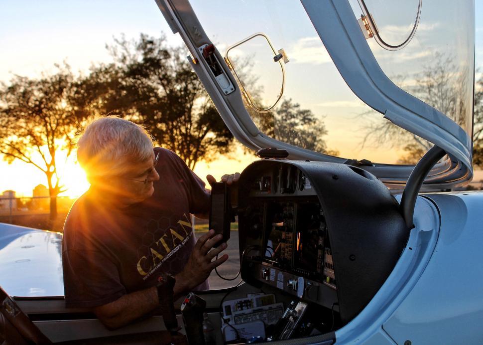 Free Image of Pilot enjoying sunset in an airplane cockpit 