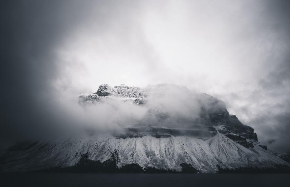 Free Image of Majestic mountain obscured by misty clouds 