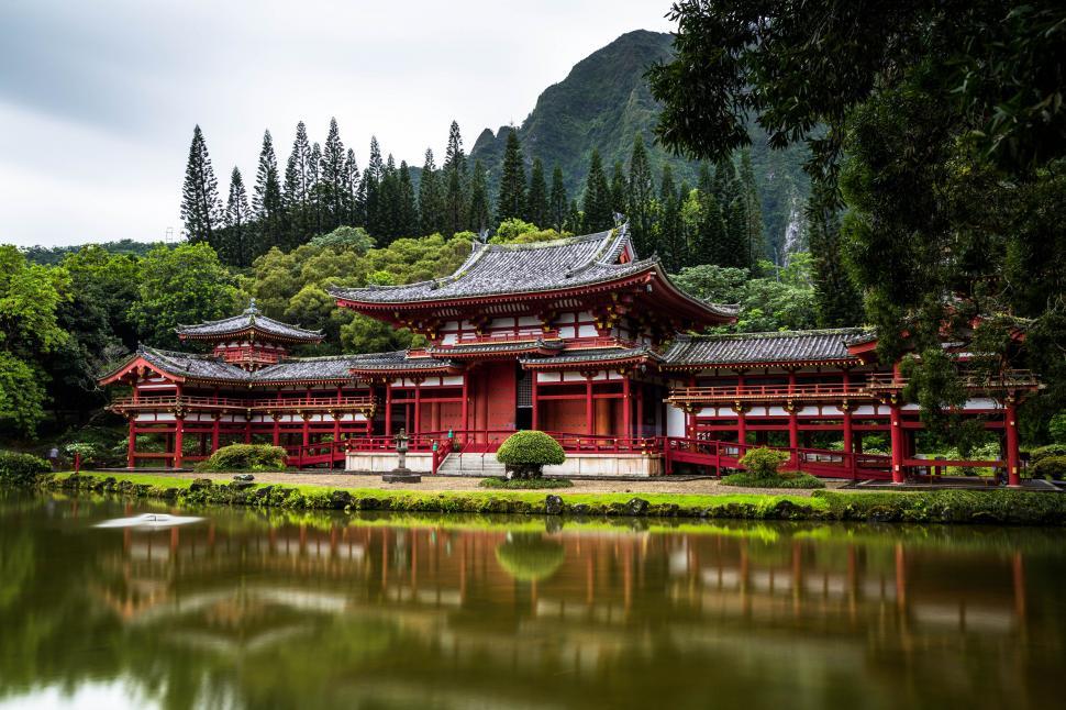 Free Image of Traditional red Japanese temple by a pond 