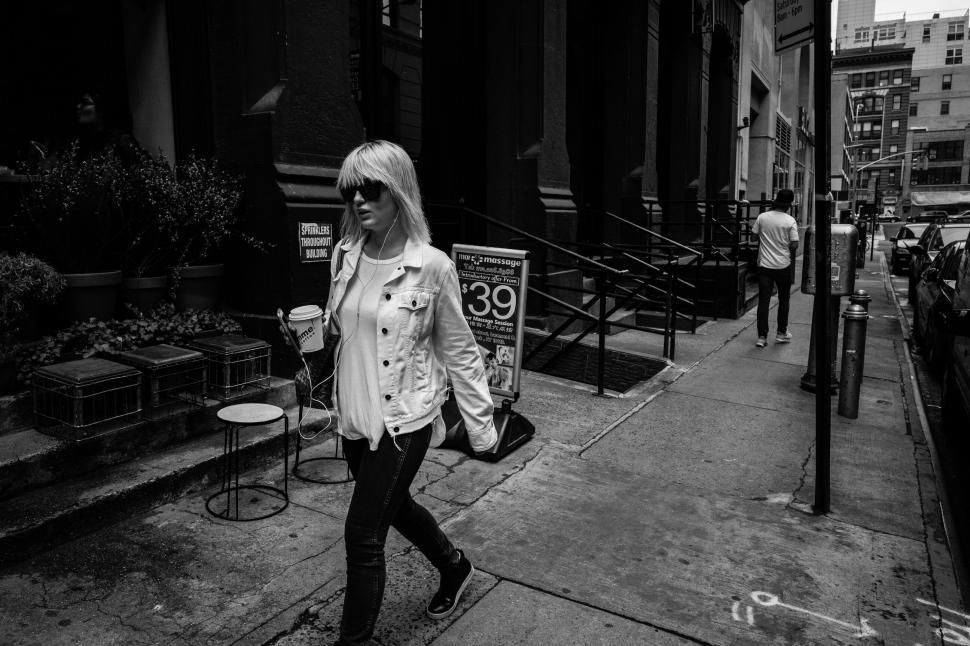 Free Image of Monochrome city life with woman walking 