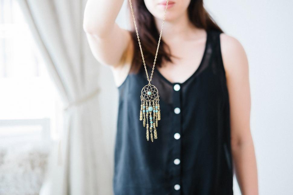 Free Image of Woman with a dreamcatcher necklace in focus 