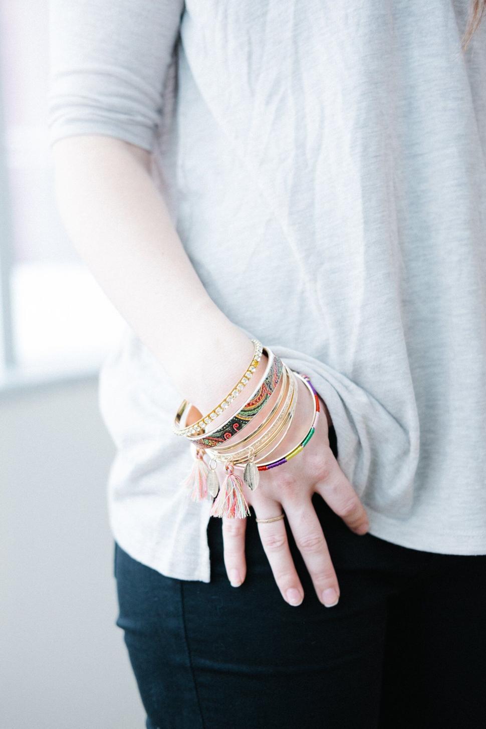 Free Image of Arm adorned with an array of colorful bracelets 