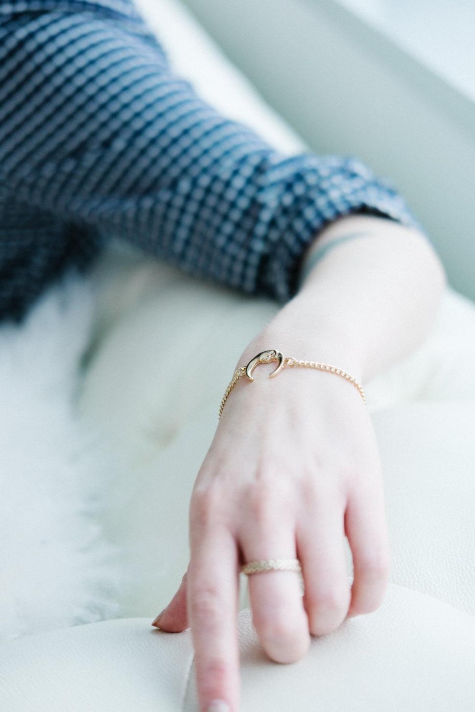 Free Image of Delicate gold bracelet on woman s wrist 