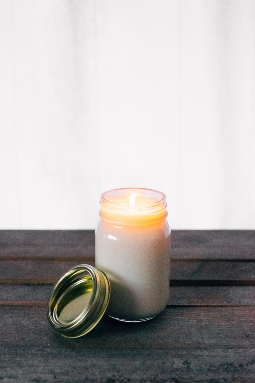 Free Image of Lit candle on wood clean background 