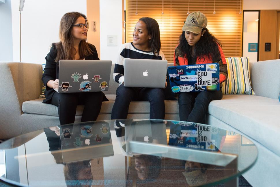 Free Image of Group of women working on laptops on a couch 