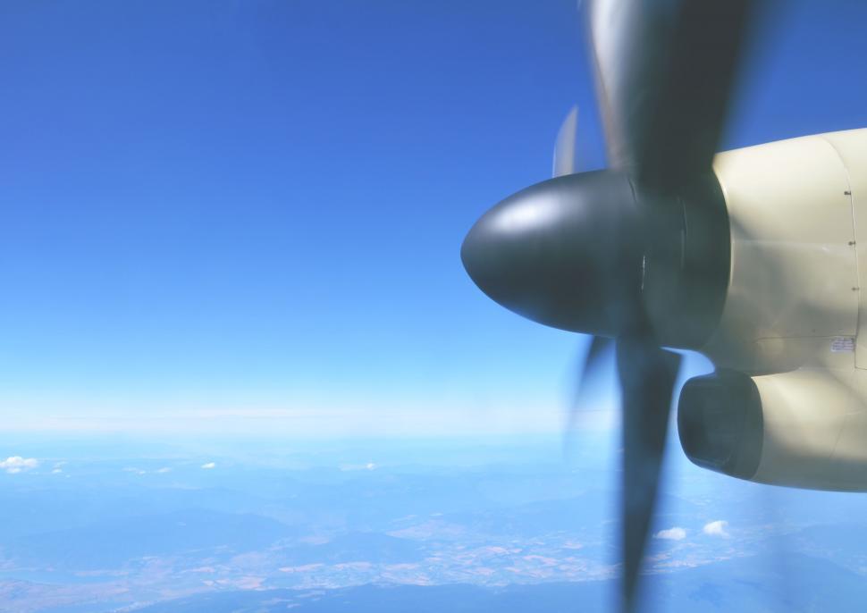 Free Image of Airplane propeller and wing over landscape 