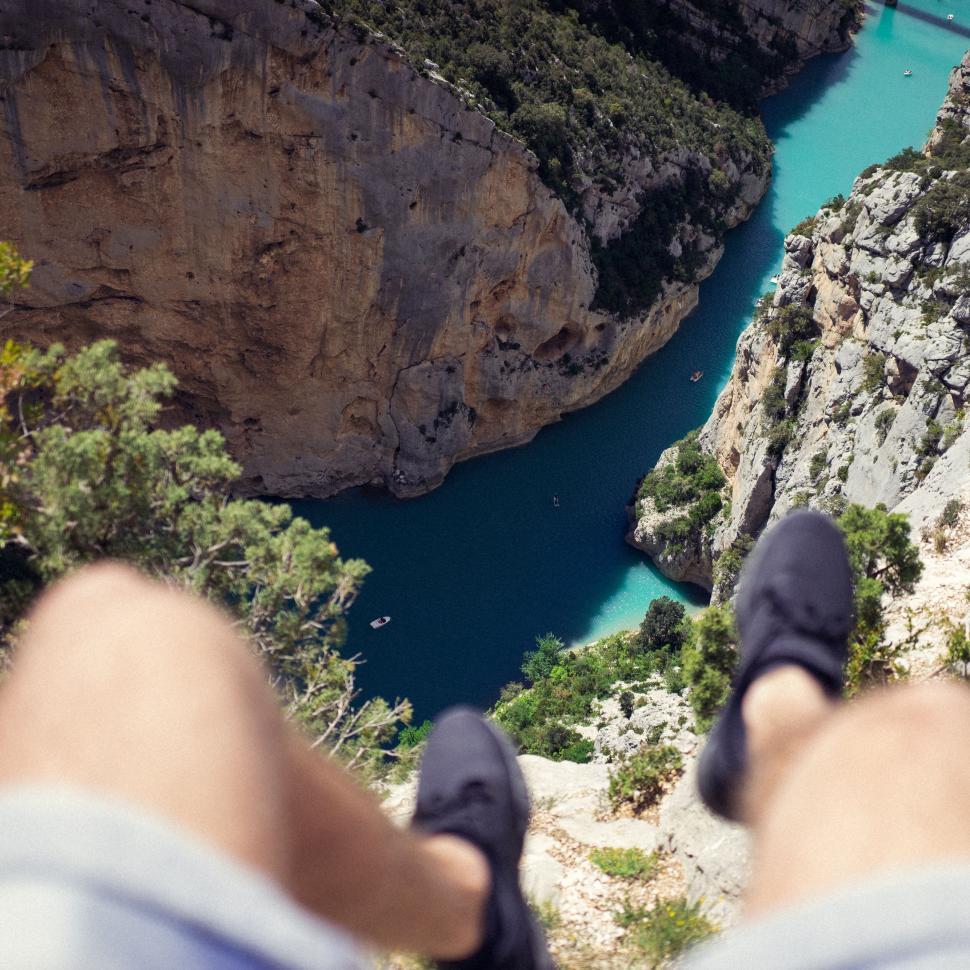 Free Image of Adventurer s feet dangling over a cliff 