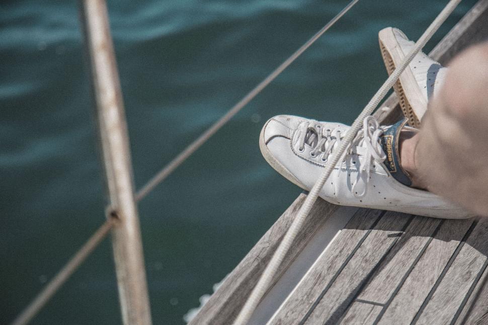 Free Image of Casual white sneaker on boat deck 