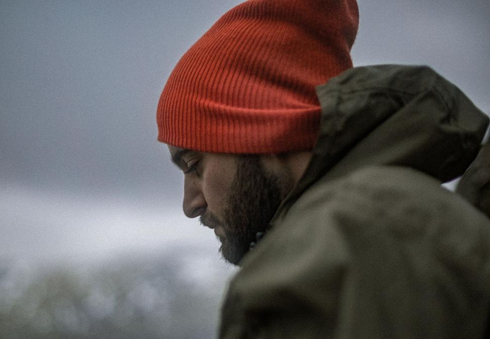 Free Image of Man in a red beanie facing away from camera 