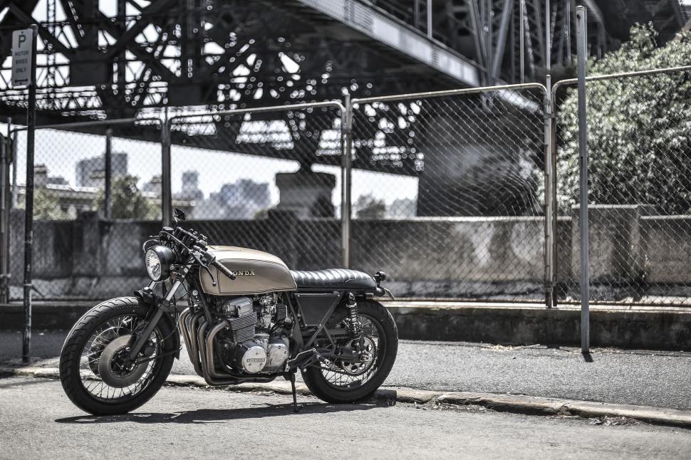 Free Image of Vintage motorcycle by an industrial bridge 