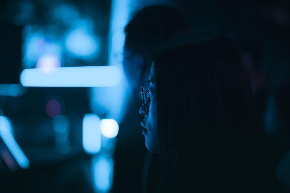 Free Image of Silhouette of a person in neon blue lights 