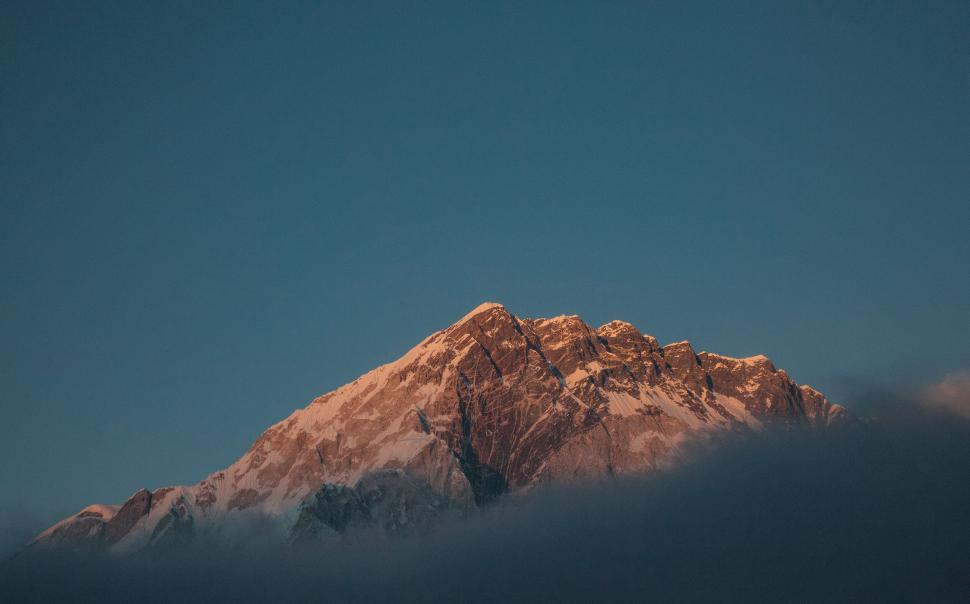 Free Image of Sunset glow on snow-capped peaks in mountains 