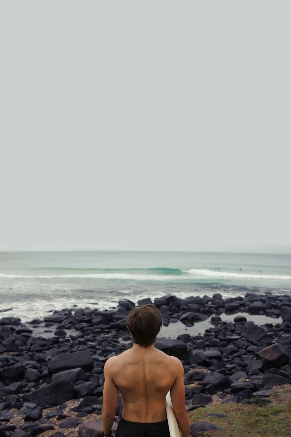 Free Image of Surfer contemplating the waves 