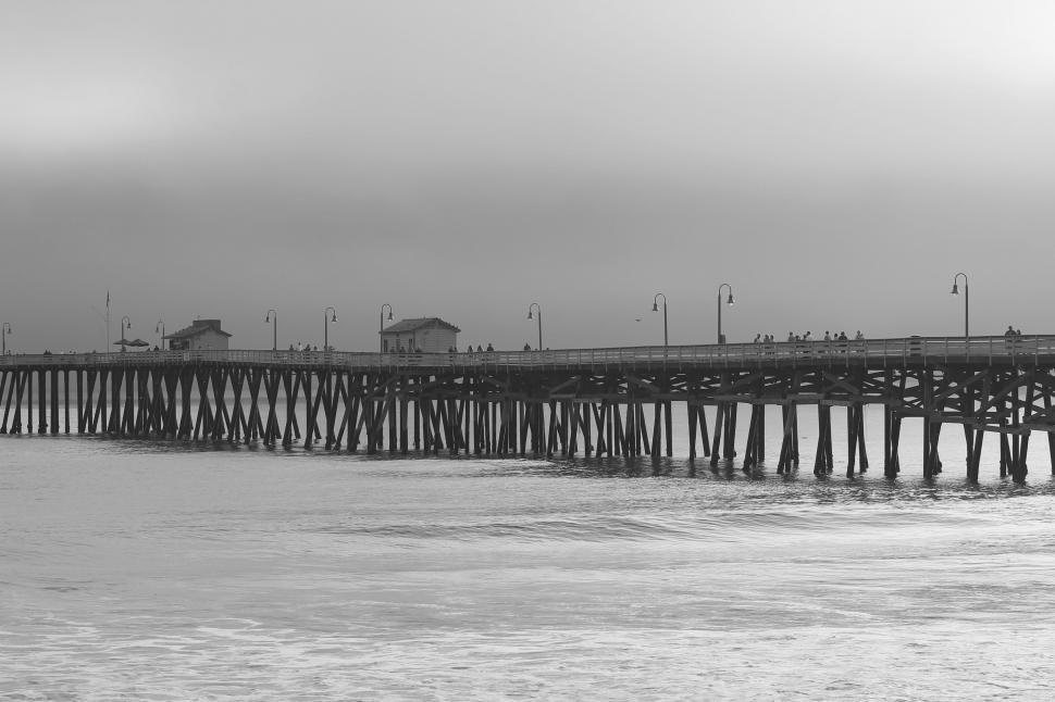 Free Image of Black and white pier with reflections on water 