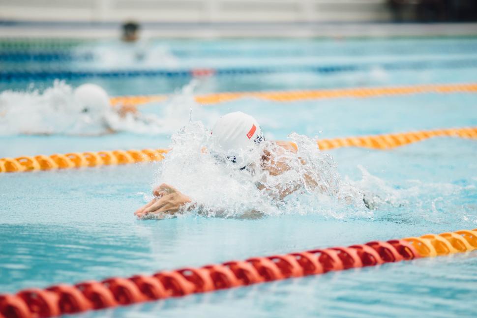 Free Image of Swimmer competing in a pool race 
