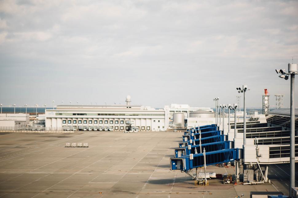 Free Image of Deserted airport terminal with boarding bridges 