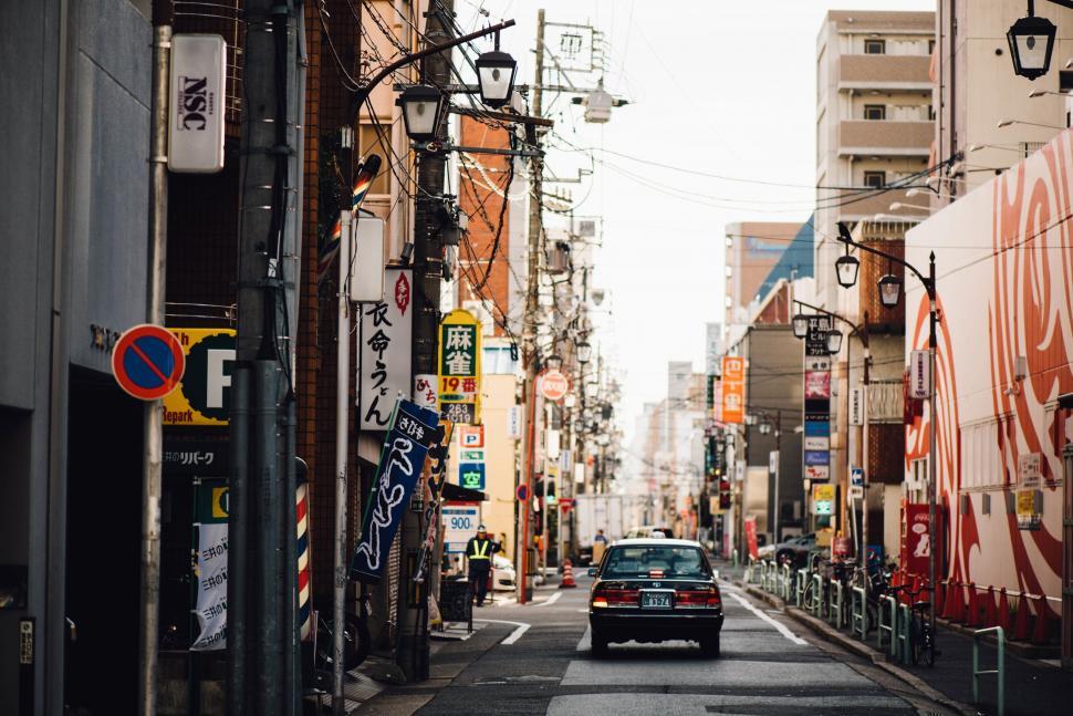 Free Image of Japanese street scene with signs and a lone car 