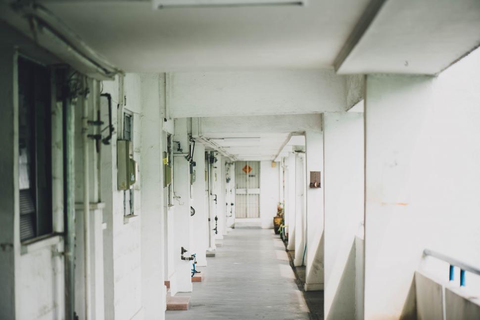 Free Image of Empty corridor with open doors and plants 