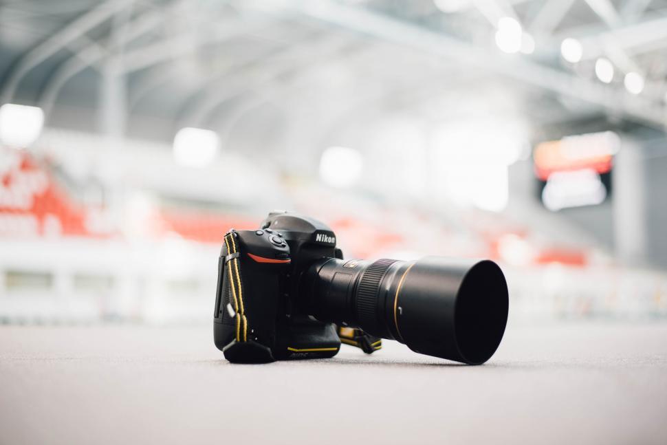 Free Image of Professional Nikon camera on a white surface 