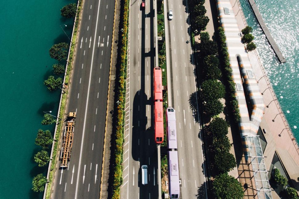 Free Image of Aerial view of a red bus on a city road 