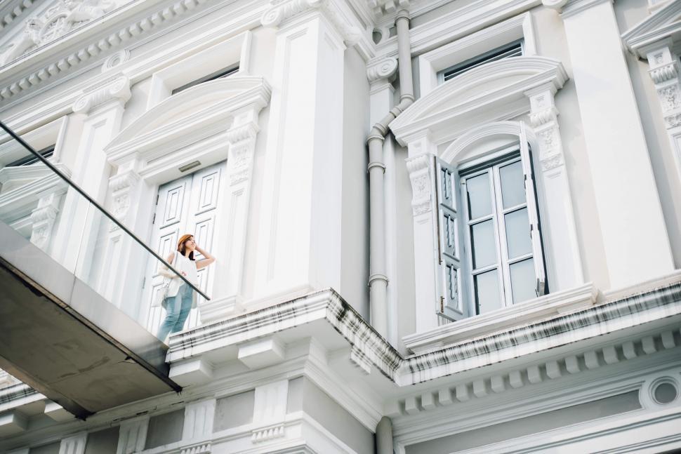 Free Image of Woman on balcony of neoclassical architecture 