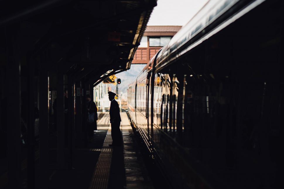 Free Image of Train station platform with silhouette of a person 