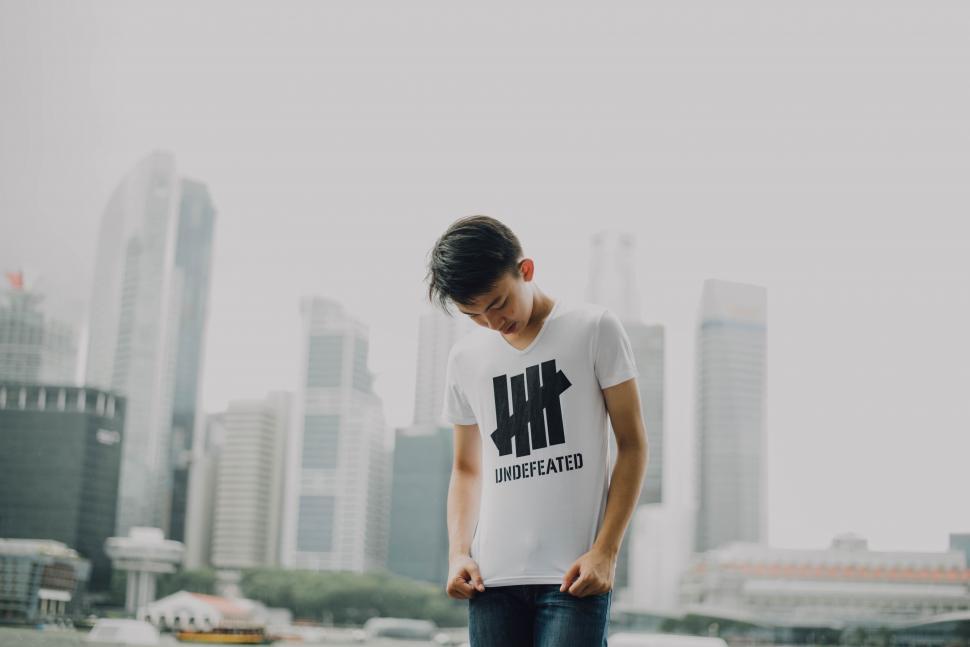 Free Image of Stylish man in a graphic t-shirt posing 